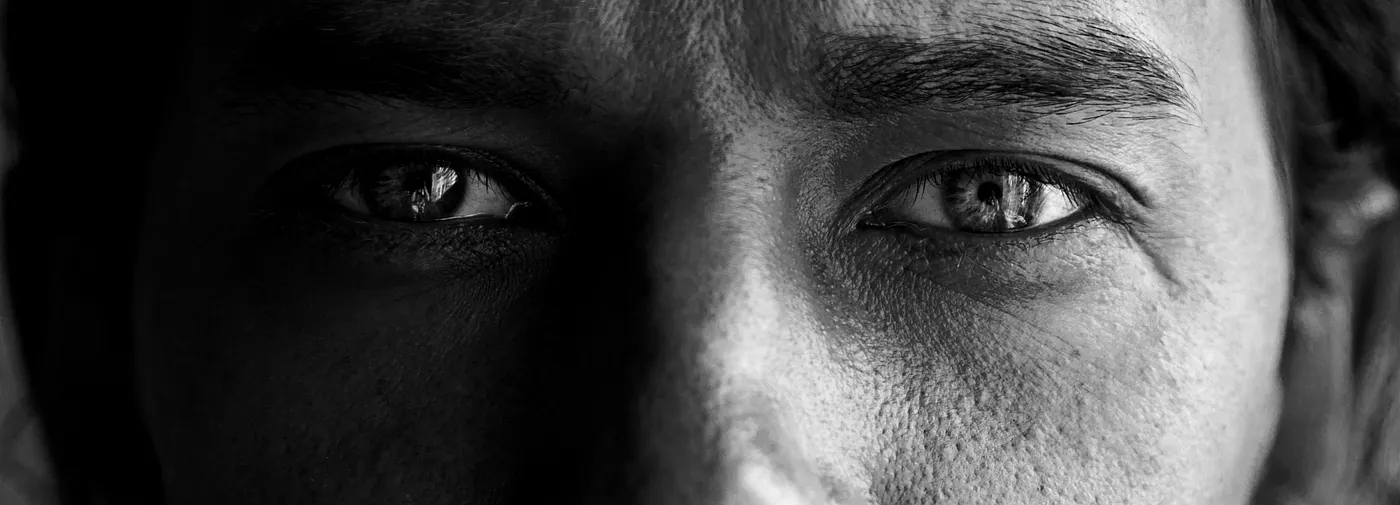 Black and white panoramic close-up of a person's eyes with dramatic split lighting — Crafting Authenticity